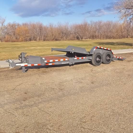 Split tilt-deck equipment trailer with the rear section tilted to load